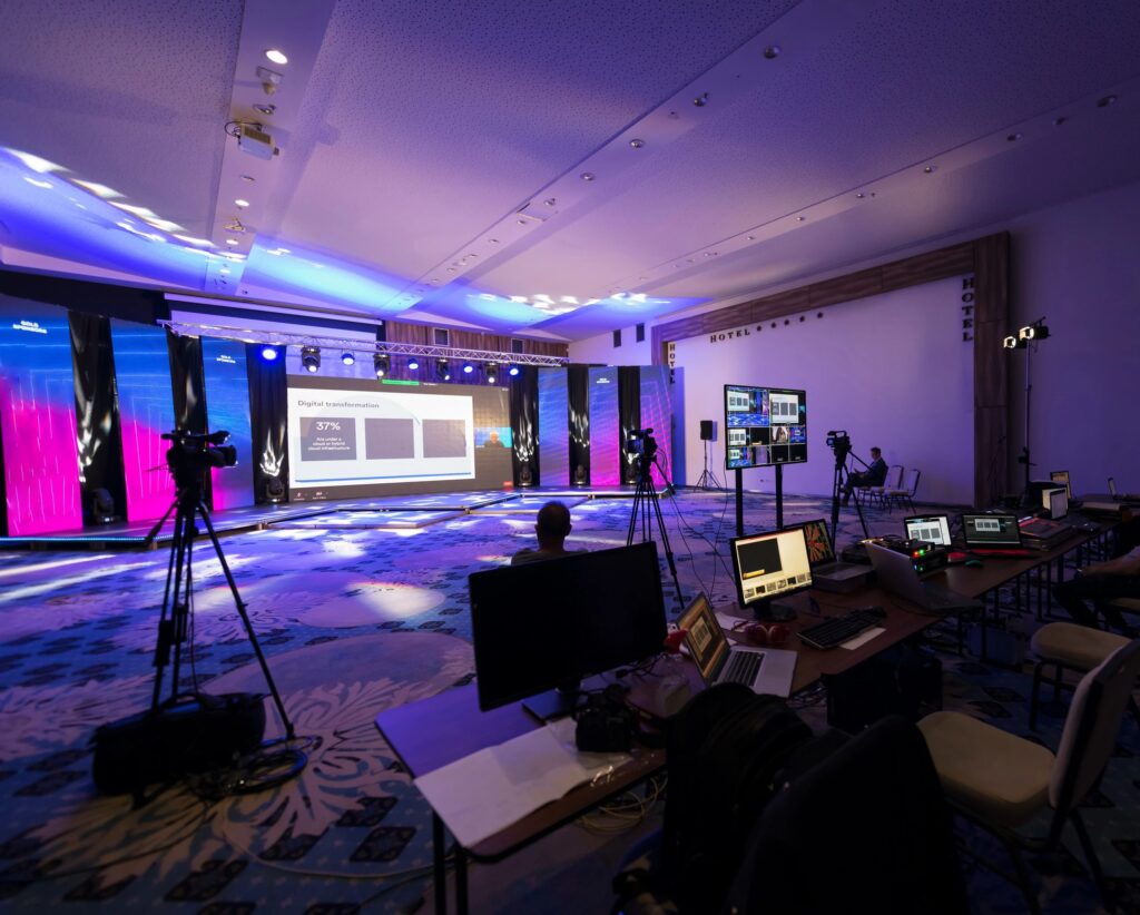 Corporate event stage with LED display and live video production equipment