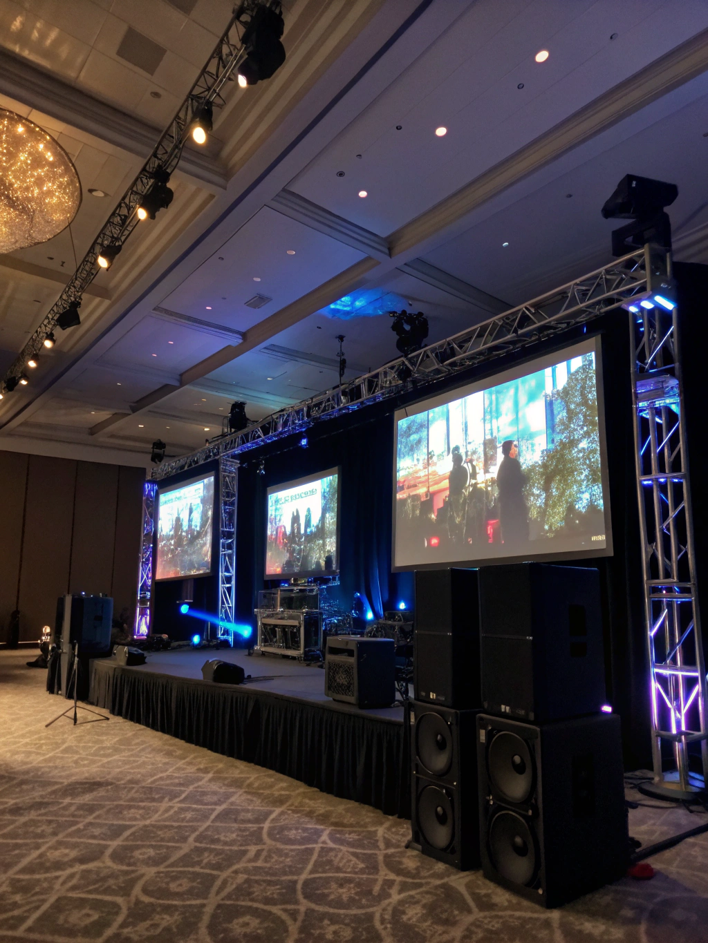 Corporate ballroom meeting setup with presentation screens and audio